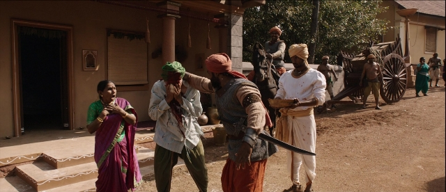 Wide shot frame from Bãhubali: The Beginning — standing, door, hand