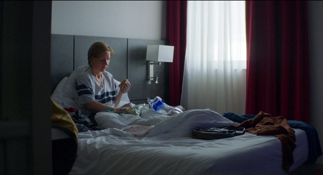 Frame from Anatomie d'une chute — sitting, book, room