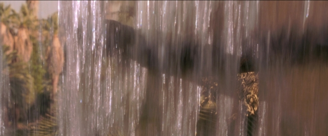 Frame from Anaconda — standing, shirt, water