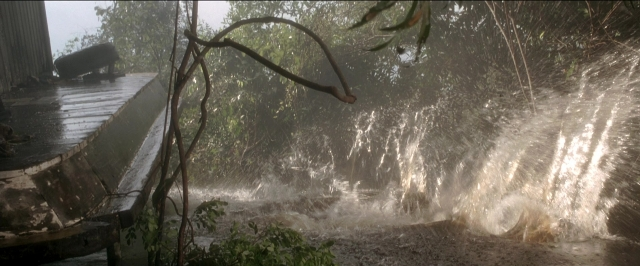 Wide shot frame from Anaconda — water, pipe, fountain