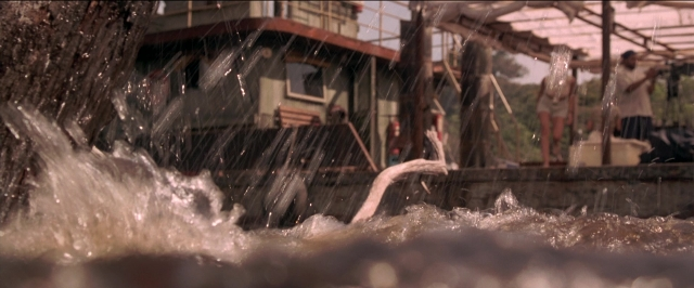 Wide shot frame from Anaconda — standing, water, fountain