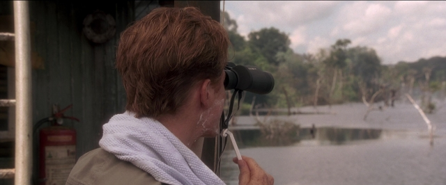 Wide shot frame from Anaconda — standing, fire, water