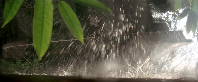 Wide shot frame from Anaconda — water, fountain