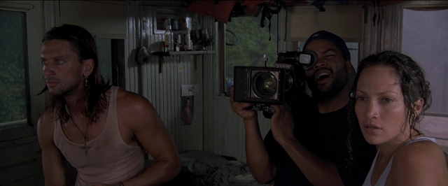 Wide shot frame from Anaconda — room, shirt, beard