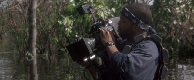 Wide shot frame from Anaconda — standing, shirt, water