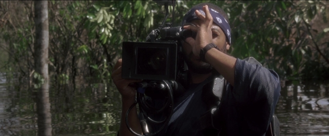 Wide shot frame from Anaconda — standing, hat, shirt