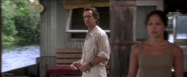 Wide shot frame from Anaconda — standing, hand, shirt
