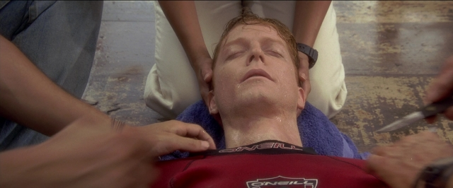 Medium shot frame from Anaconda — shirt, face, knife