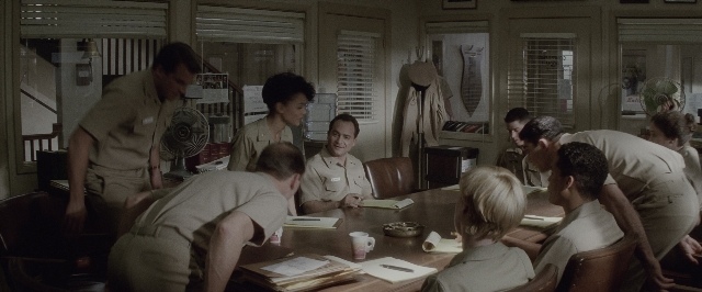 Wide shot frame from A Few Good Men — sitting, book, standing