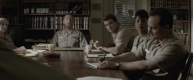 Wide shot frame from A Few Good Men — sitting, book, plate