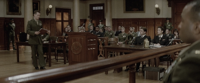 Wide shot frame from A Few Good Men — sitting, book, standing