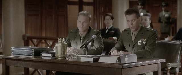Wide shot frame from A Few Good Men — sitting, book, room