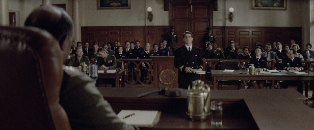 Wide shot frame from A Few Good Men — sitting, book, standing