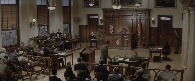 Wide shot frame from A Few Good Men — sitting, book, standing