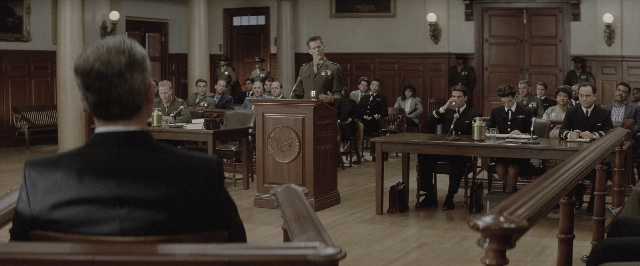 Wide shot frame from A Few Good Men — sitting, standing, table