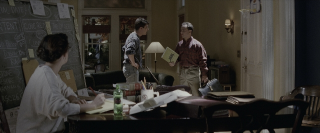 Wide shot frame from A Few Good Men — sitting, book, room