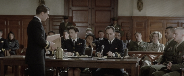 Wide shot frame from A Few Good Men — sitting, book, standing