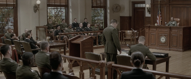 Wide shot frame from A Few Good Men — sitting, standing, room