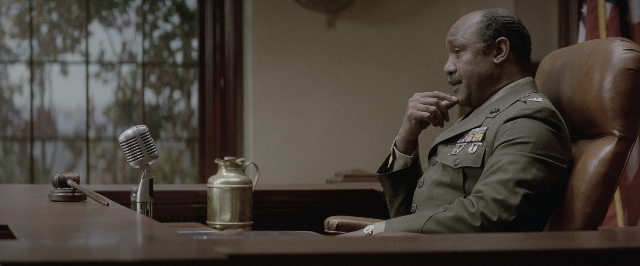 Wide shot frame from A Few Good Men — sitting, table, uniform
