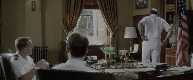 Wide shot frame from A Few Good Men — sitting, book, standing