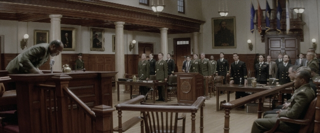 Wide shot frame from A Few Good Men — sitting, standing, table
