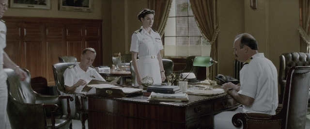 Wide shot frame from A Few Good Men — sitting, desk, book