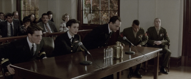 Wide shot frame from A Few Good Men — sitting, standing, room