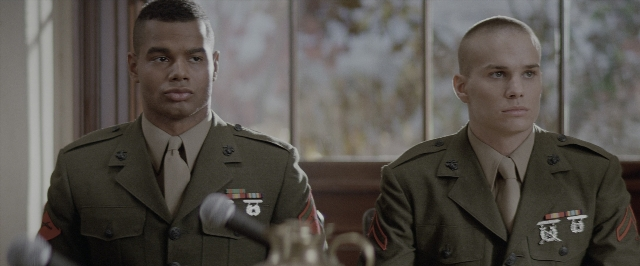 Wide shot frame from A Few Good Men — sitting, table, suit