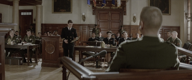 Wide shot frame from A Few Good Men — sitting, book, standing