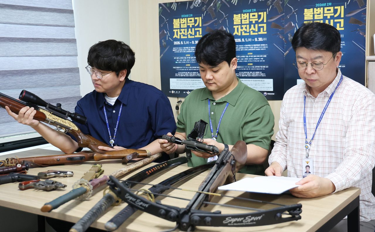 Police officers inspect illegal weapons voluntarily surrendered by their owners during a self-reporting period at Suwon Jangan Police Station in Suwon, Gyeonggi Province, on Sept. 