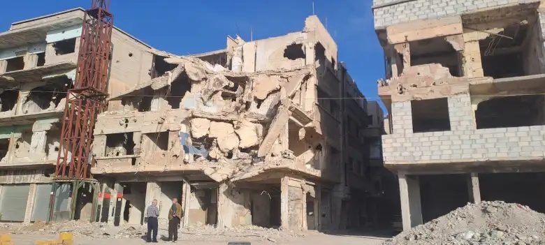 Men talking amid city ruins