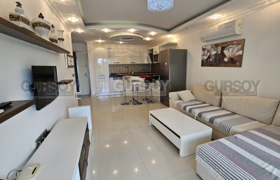 Квартира 1+1 с мебелью в 150 метрах от моря в районе Каргыджак в Турции - фото 11