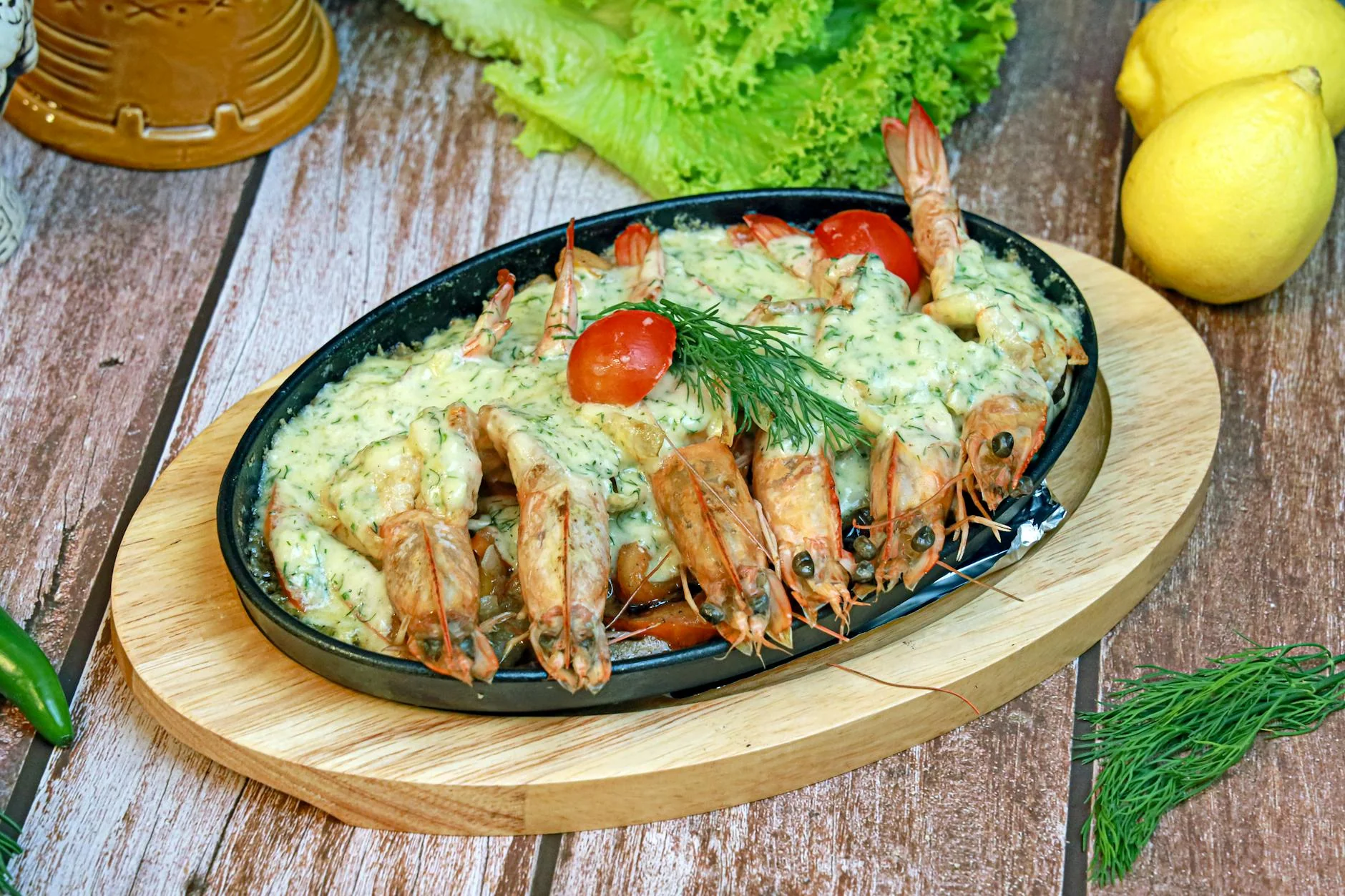 A mouthwatering seafood platter featuring shrimp with herb sauce, garnished with vegetables.
